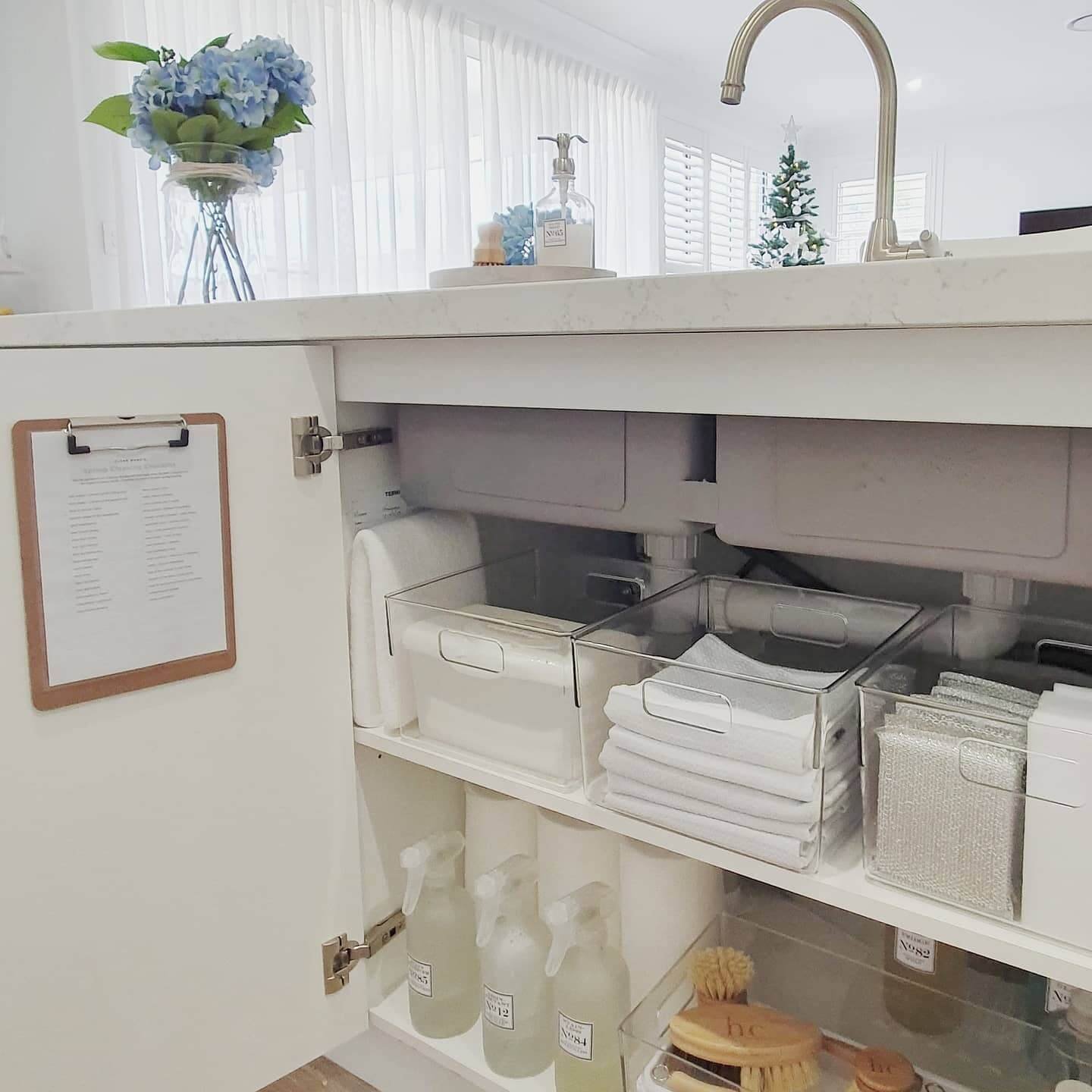Clear bins and soft towels create a stylish organized space