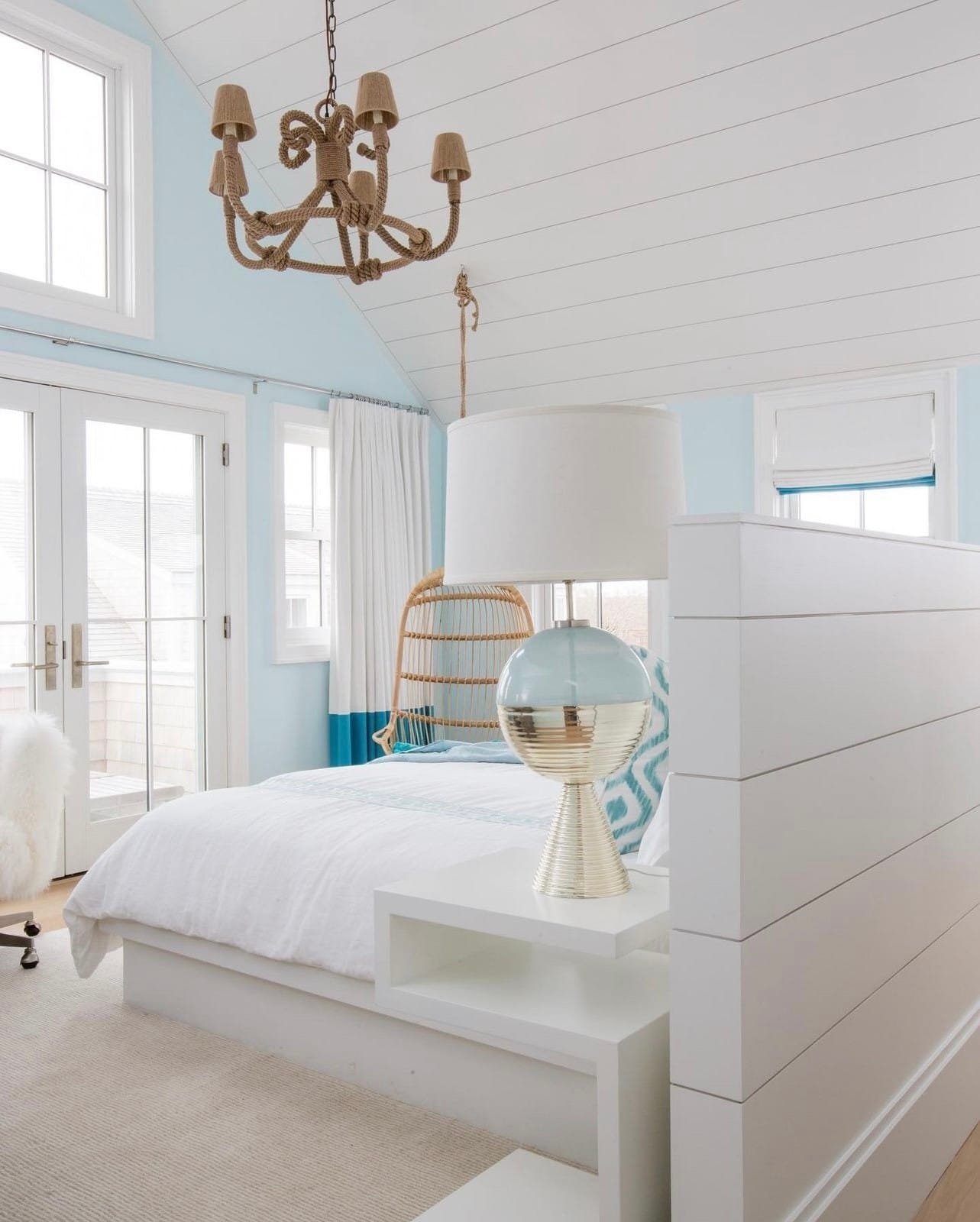 Coastal bedroom design with soft blues and nautical accents