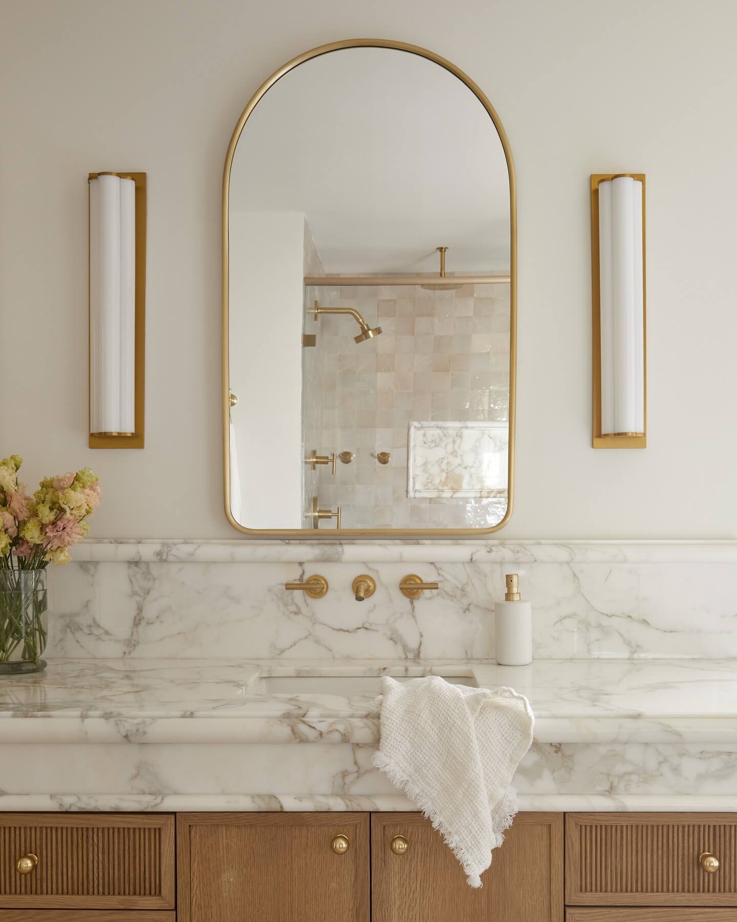 Soft textured tiles create a serene and luxurious bathroom design